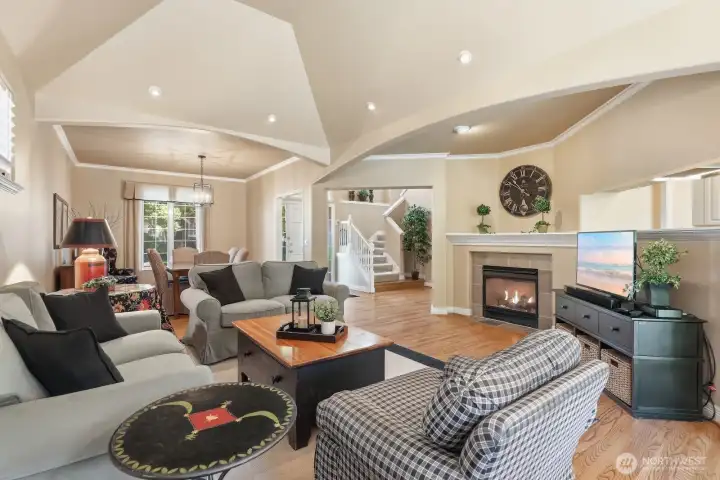 An elegant main living area offers a comfortable place to gather, with architectural arches, a fireplace focal point, and an easy connection to the dining room and kitchen.