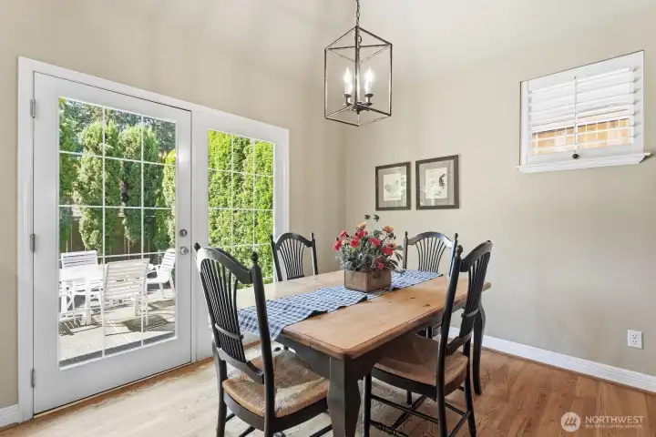A charming kitchen nook opens directly to the patio, creating a bright spot for casual meals with a view of the surrounding greenery.