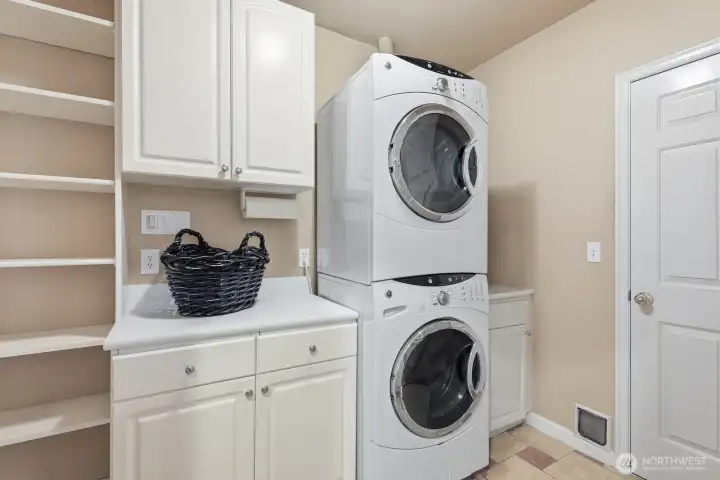A well-designed laundry room with quartz countertops, built-in cabinetry, and extra storage to keep everyday tasks organized and efficient.