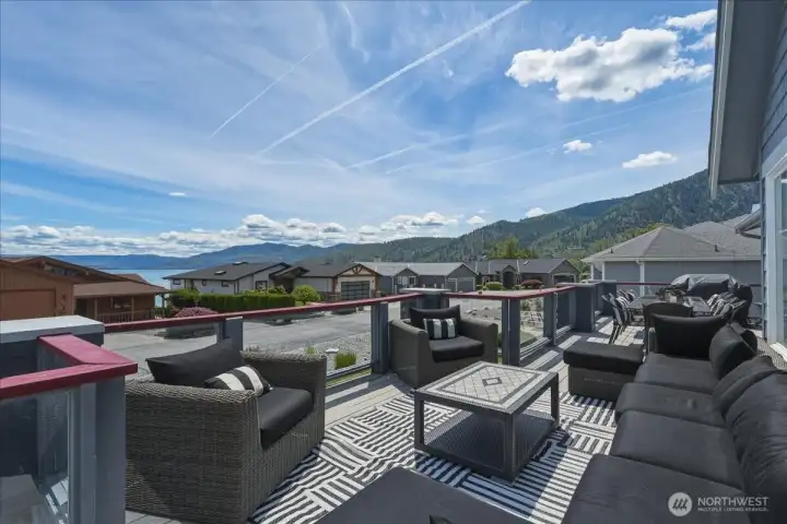 Large deck has seating area adjacent to dining