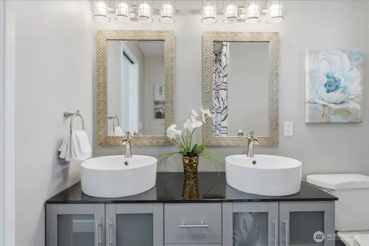 Dual vanity and raised sinks in the primary en-suite bath