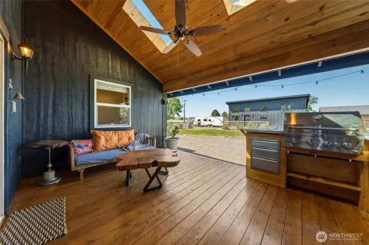 248 Side Deck / Outdoor Kitchen featuring sitting area, grill, sink, and refrigerator