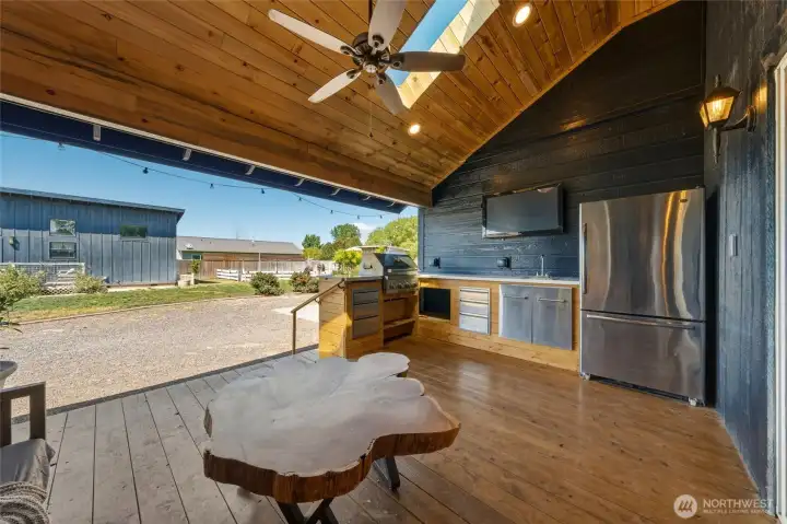248 Side Deck / Outdoor Kitchen Kitchen featuring sitting area, grill, sink, and refrigerator