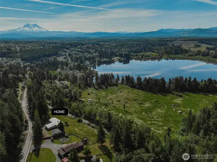 Unobstructed view of Mt Rainier and the Cascades. Can see Harts Lake through the trees.