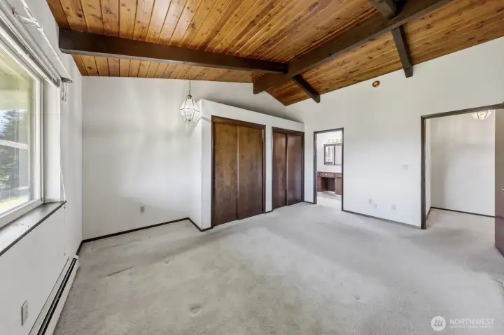 Primary bedroom on the main floor with double closets and 3/4 bath