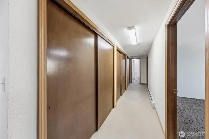 Downstairs hallway leading to 2 bedrooms and a 3/4 bath and so much more storage!