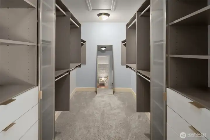 Large walk-in closet in the primary, complete with custom California Closets Large walk-in closet in the primary, complete with custom California Closets