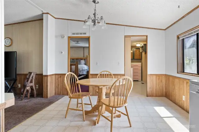 Dining with laundry access to the right & primary bedroom access with bath to left.