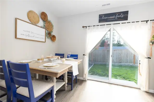 Spacious dining and sliding doors to the fully fenced backyard