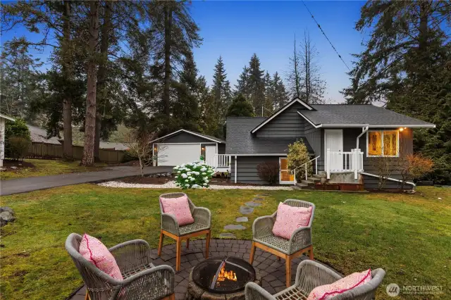 Enjoy lazy evenings at the firepit. You also see the second entrance to the home, and this door would take you into the dining area. NB. The hydrangea bush has been digitally enhanced.