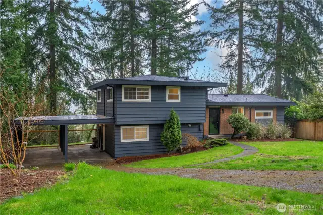 Front of house w/ 2 space carport