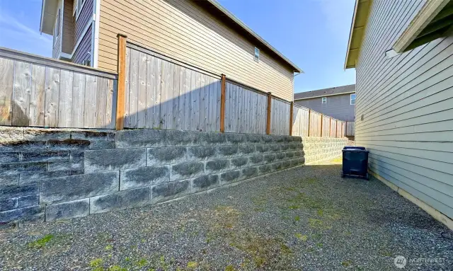 Side yard with brick wall/fence