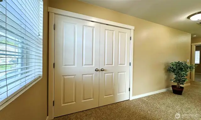 French door closets in bright & open hallway ...
