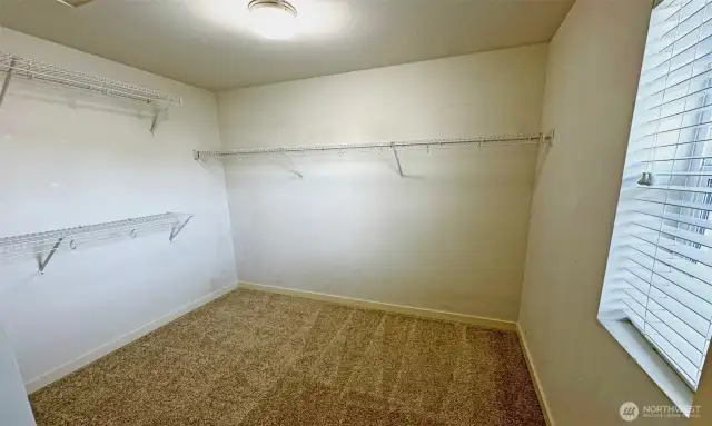Spacious walk-in closet in Primary suite with a window for fresh air!