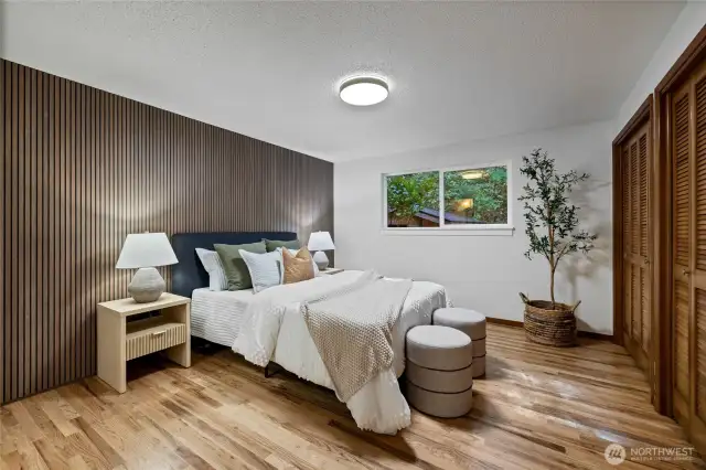 The primary suite features a sophisticated fluted wall, completing a relaxing retreat.
