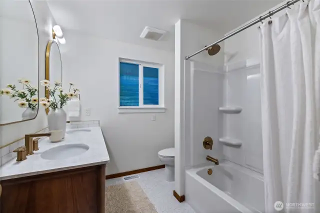 The remodeled shared bathroom features a MCM inspired vanity.