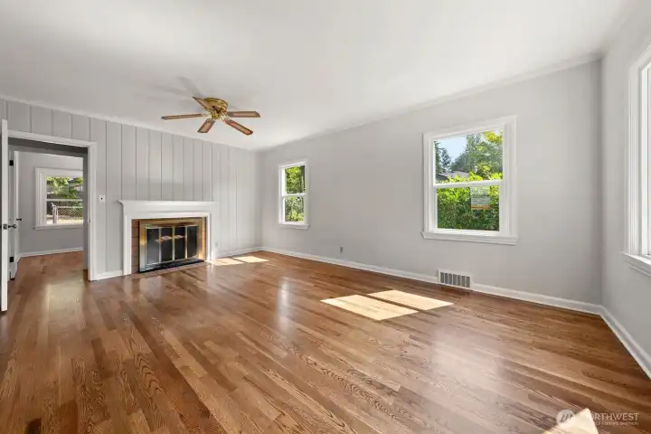 Living Room as shown today. The oak hardwood floors were protected for decades, now beautifully stained!  The home has been freshly painted both the interior and exterior;  Benjamin Moore and Sherwin Williams, high quality paint.