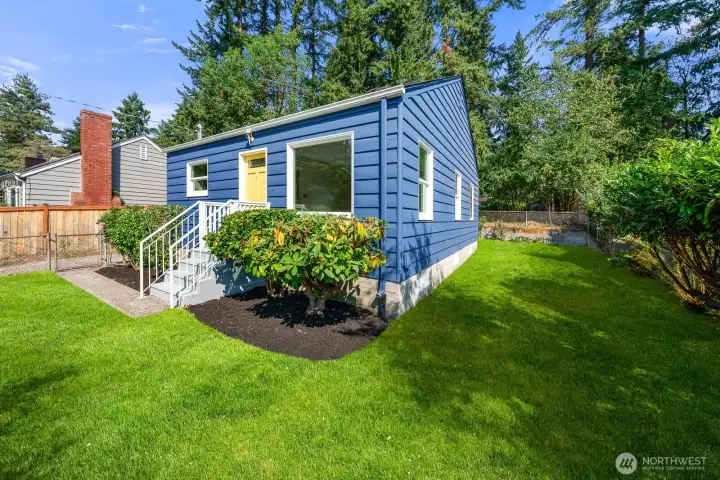 Another view of the house from the southwest. Lots of space between the house and the fence to the backyard.  (virtually staged)