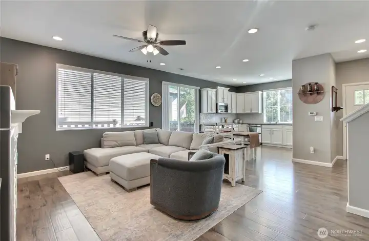 View of your family room from the fireplace to the kitchen, lots of windows and the patio doors let in all the light.
