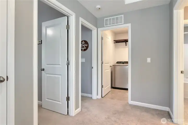Hallway view from landing, from left you have linen closet, bedroom, bedroom and utility room. SO smart to have your utility room upstairs where all the clothes go off and on!
