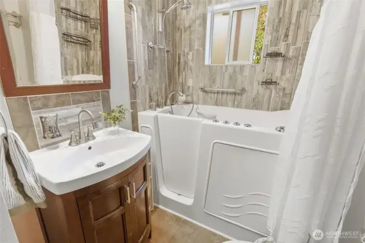 Easy access walk-in bath with tile wall and floor
