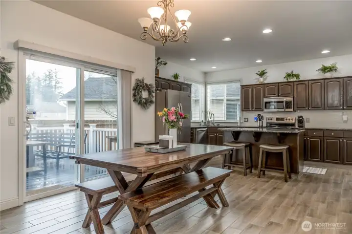 Dining room and kitchen feature beautiful and durable wood-look tile flooring