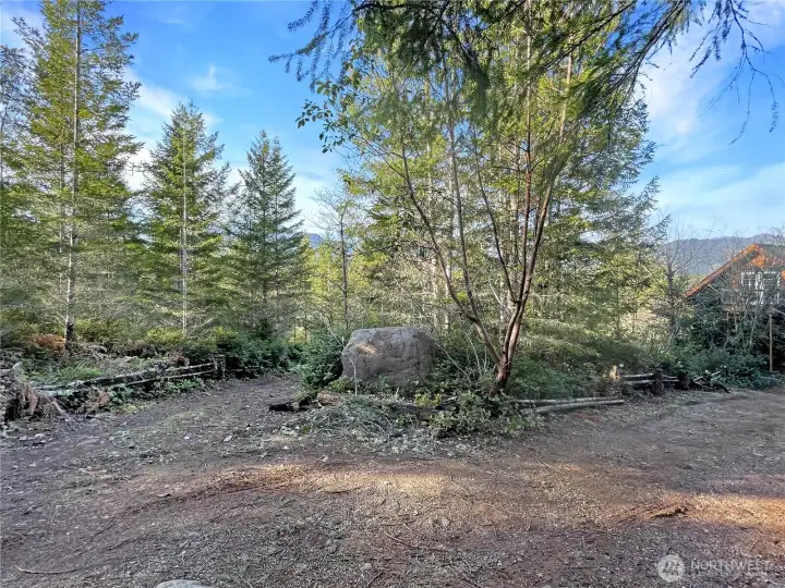 Just off street. Right is driveway to house. Left is driveway to the lower level. Nice rock to engrave name or ?