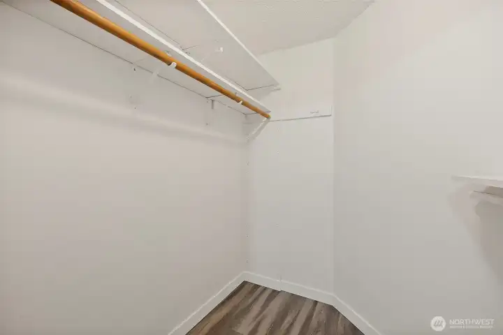 Primary bedroom walking closet with updated flooring.