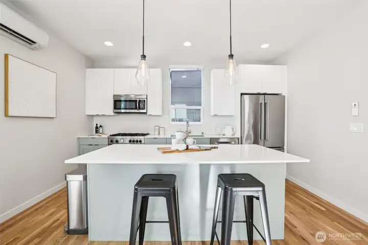 Another rarity in a townhome: a true gathering space like this in the kitchen. Tons of space for multiple chefs plus those who love to watch you work.