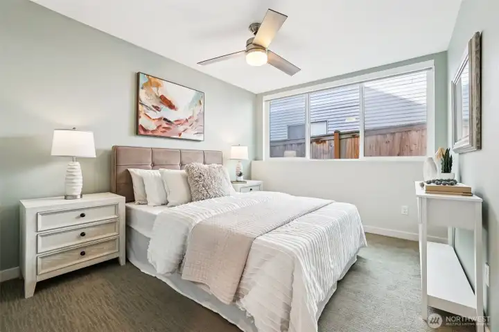 Downstairs, find two more spacious bedrooms - but don't expect them to be dark and tiny like most cookie cutter homes!