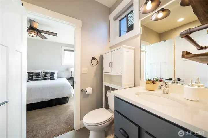 View of main level bathroom looking towards the Primary Bedroom Suite.