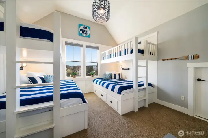 View of upper level bedroom with built-in twin over queen bunk beds.