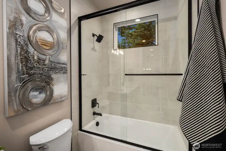 Elegant glass enclosure surrounding the tub.