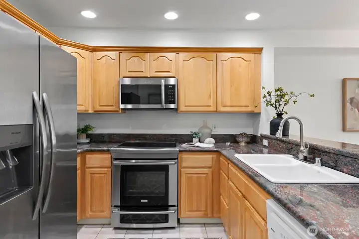 Large U-Shaped kitchen with granite slab countertops.