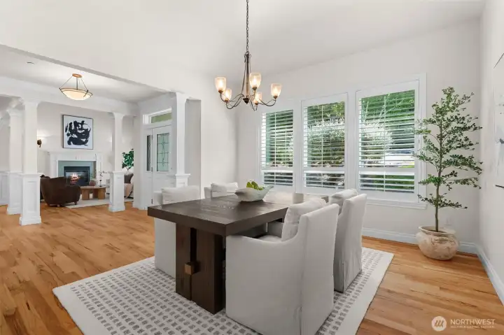 Inviting dining area with plantation shutters and an open flow to the surrounding living spaces.