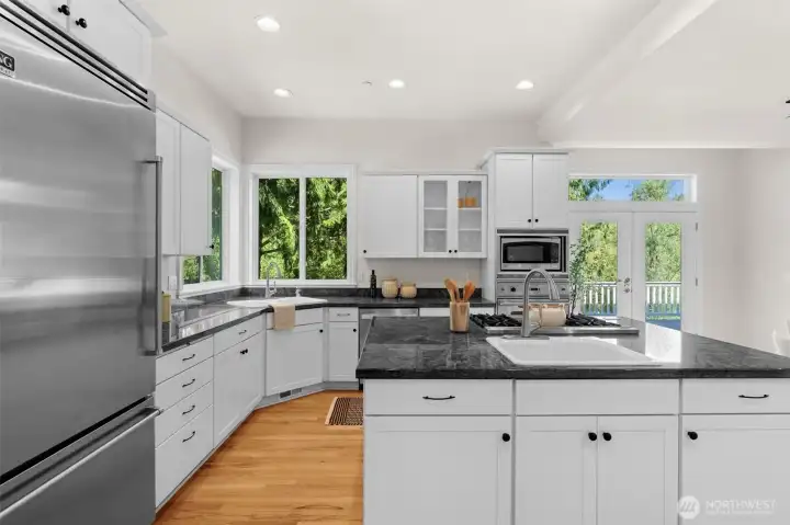 Open kitchen with center island, abundant cabinetry, and easy access to the outdoor living spaces.