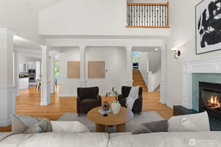 Grand living area with soaring ceilings, fireplace, and an open layout.