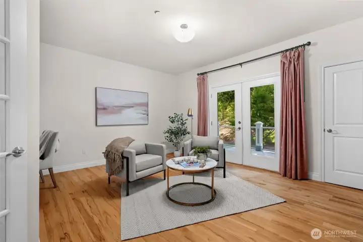 Flexible main-level room with deck access, offering a versatile space for guests, work, or everyday living.