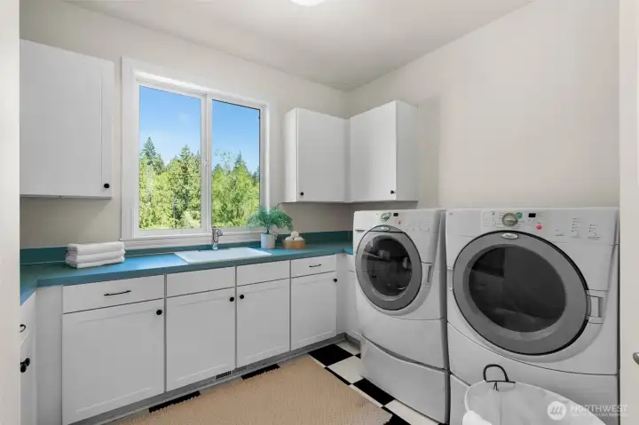 Laundry room features built-in cabinetry, utility sink, and counter space for added functionality.