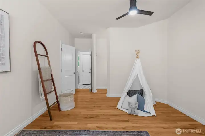 Additional view of upstairs bedroom highlighting the open layout and hardwood flooring.