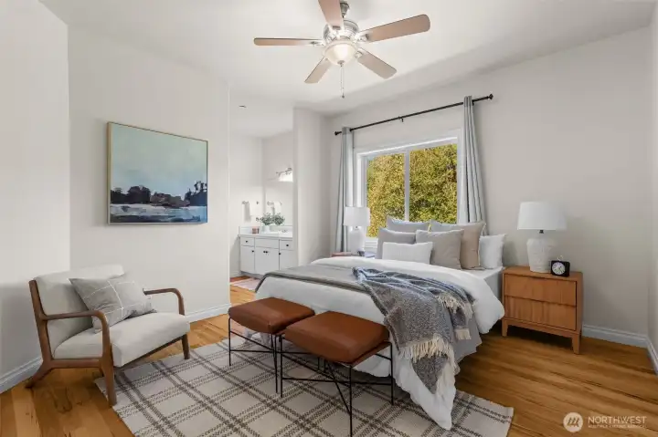 Spacious upstairs bedroom with hardwood flooring and access to nearby bathroom