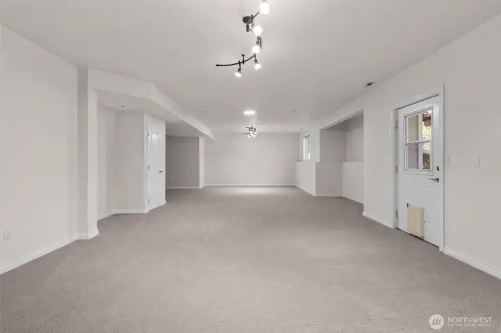 Expansive basement level offers living space with flexible functionality and access to outdoor living areas.