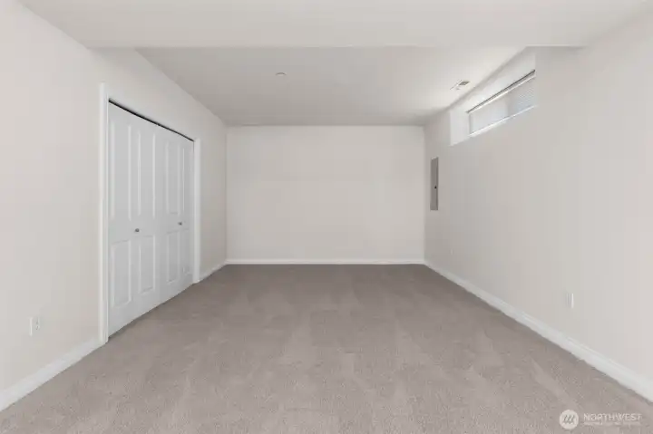 Versatile lower level space includes closet storage and room for multiple configurations.