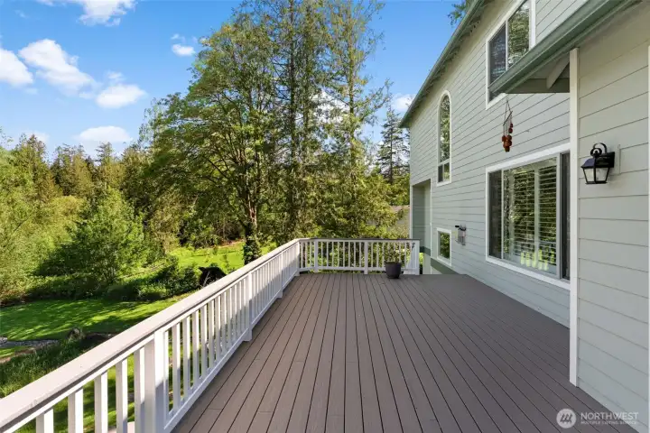 Spacious deck with railing enclosure and access from the interior living spaces.