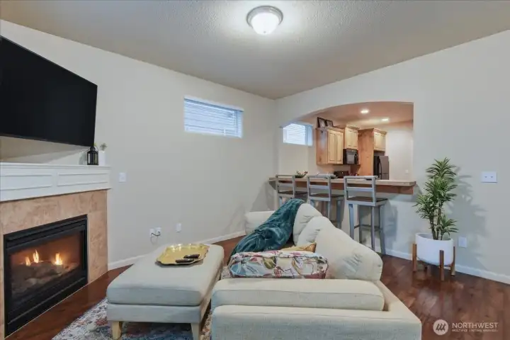 Living room, eatbar, laminate flooring, gas fireplace
