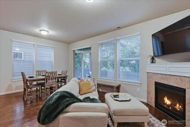 Living room, dining area, laminate flooring, gas fireplace
