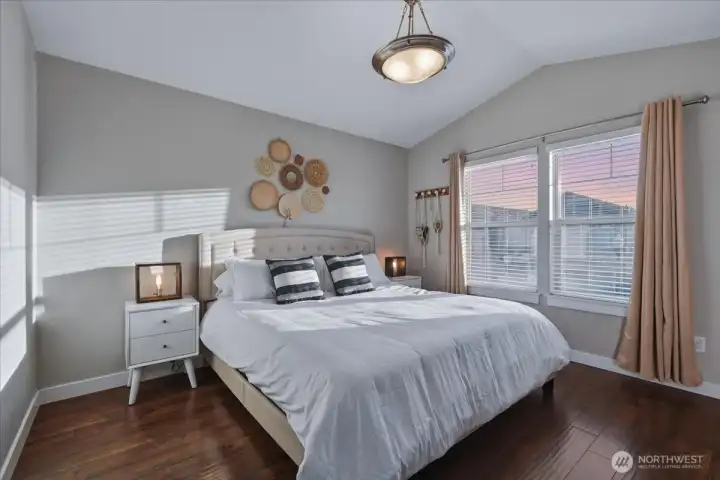 Primary suite, laminate flooring, vaulted ceiling
