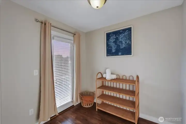 Den in primary suite, laminate flooring, covered balcony access