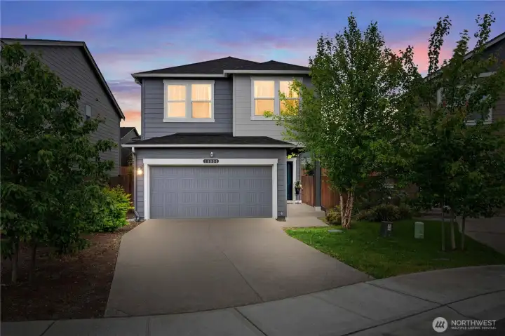 Stunning evening exterior showcasing modern architecture and welcoming entry.