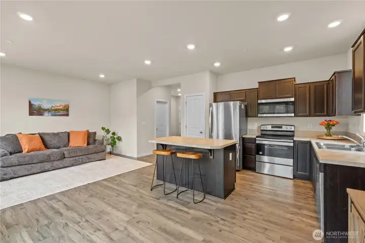 Seamless flow between living room and kitchen creates the perfect gathering space.